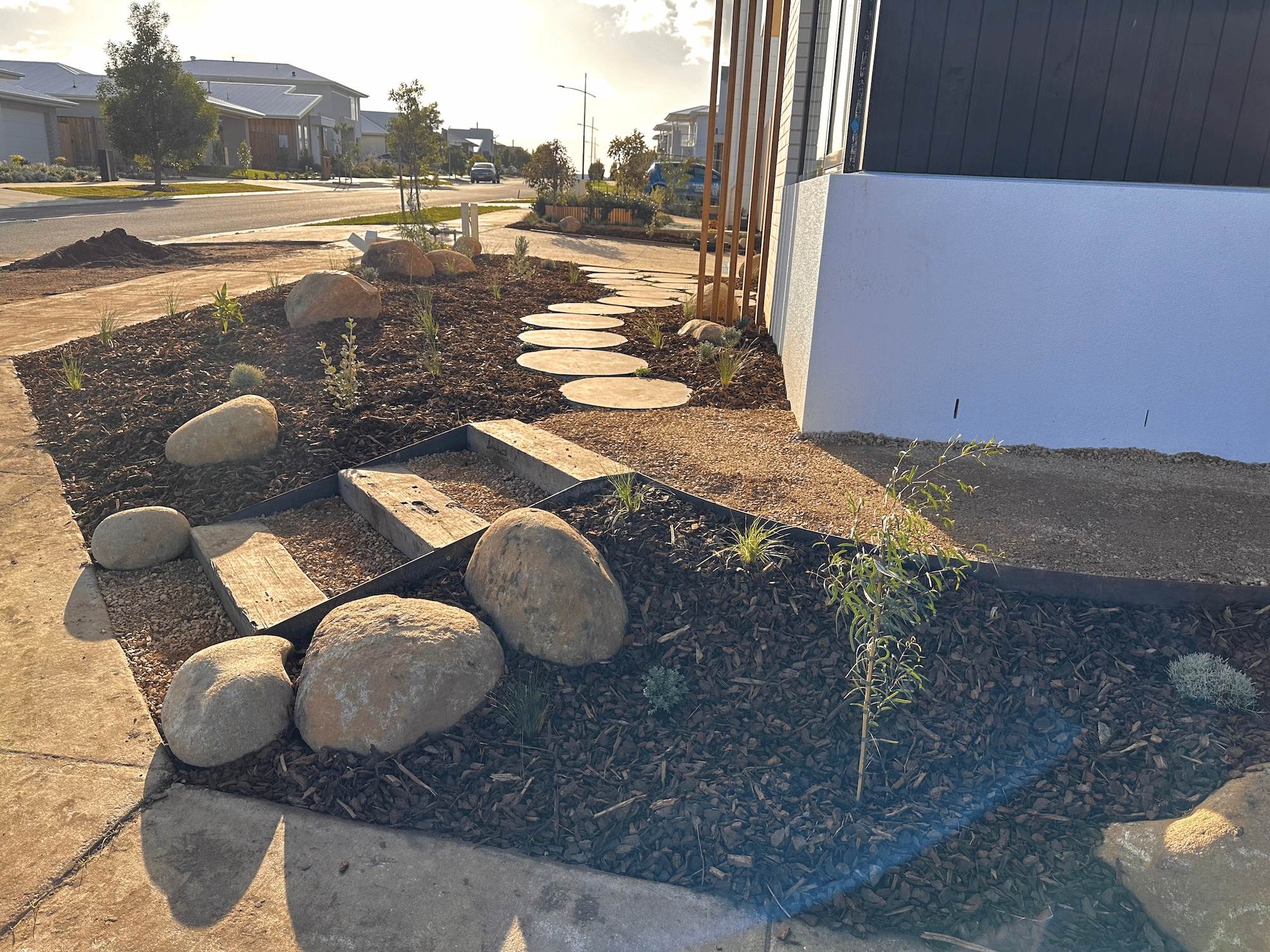 A professionally constructed landscape with a natural steps and a stone stepper path