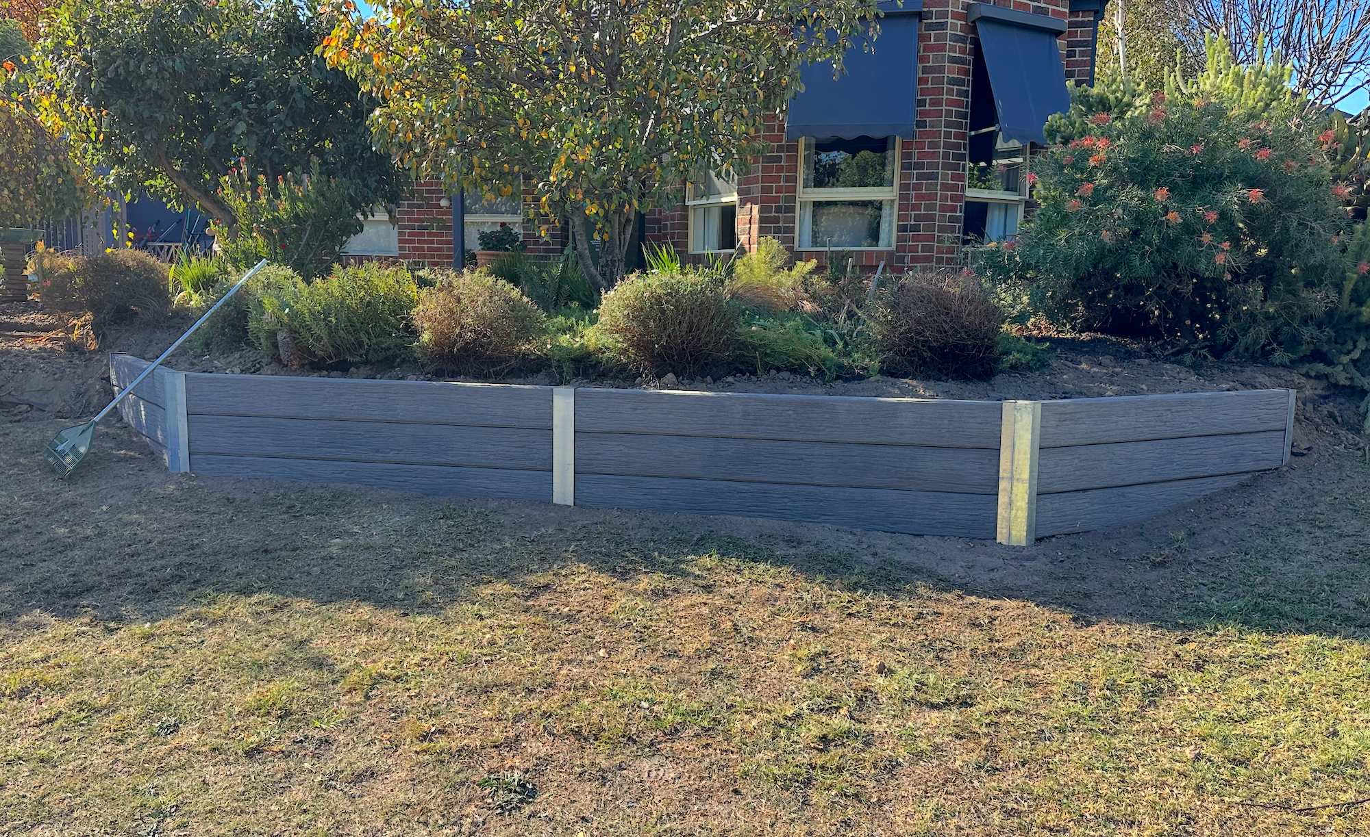 A professionally built concrete retaining wall creating a terraced garden