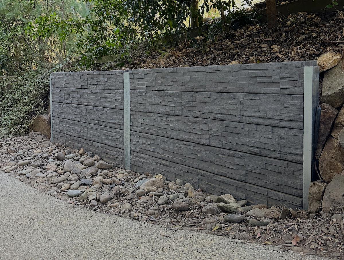 Close-up of a modern concrete sleeper retaining wall.
