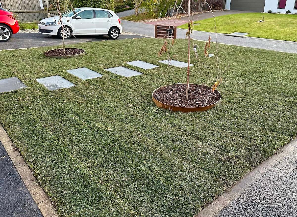 Spreading high-quality topsoil for turf underlay.